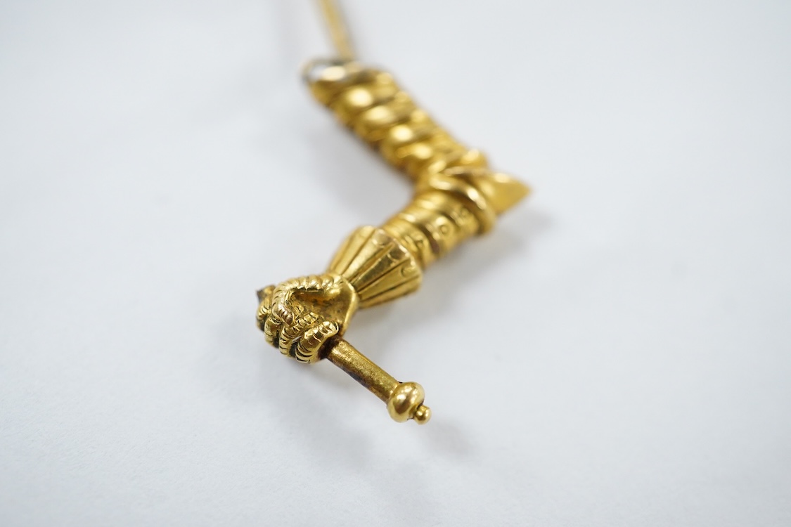 A yellow metal stick pin, the terminal modelled as a Knight's arm holding a scroll(a.f.), 79mm, together with two pairs of yellow metal and gem set ear clips including 9ct and opal doublet.